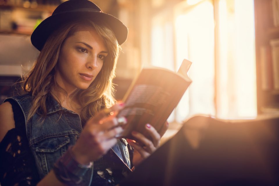 Student reading a book while studying for her exams.