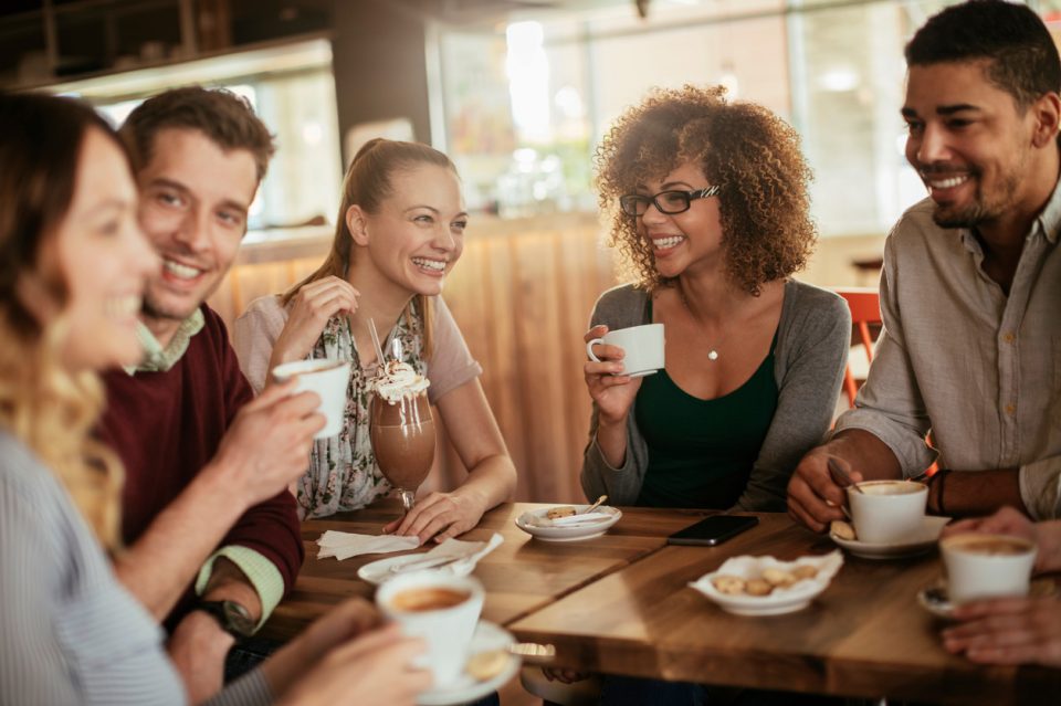 Photo of friends having coffee in cafe during lunch